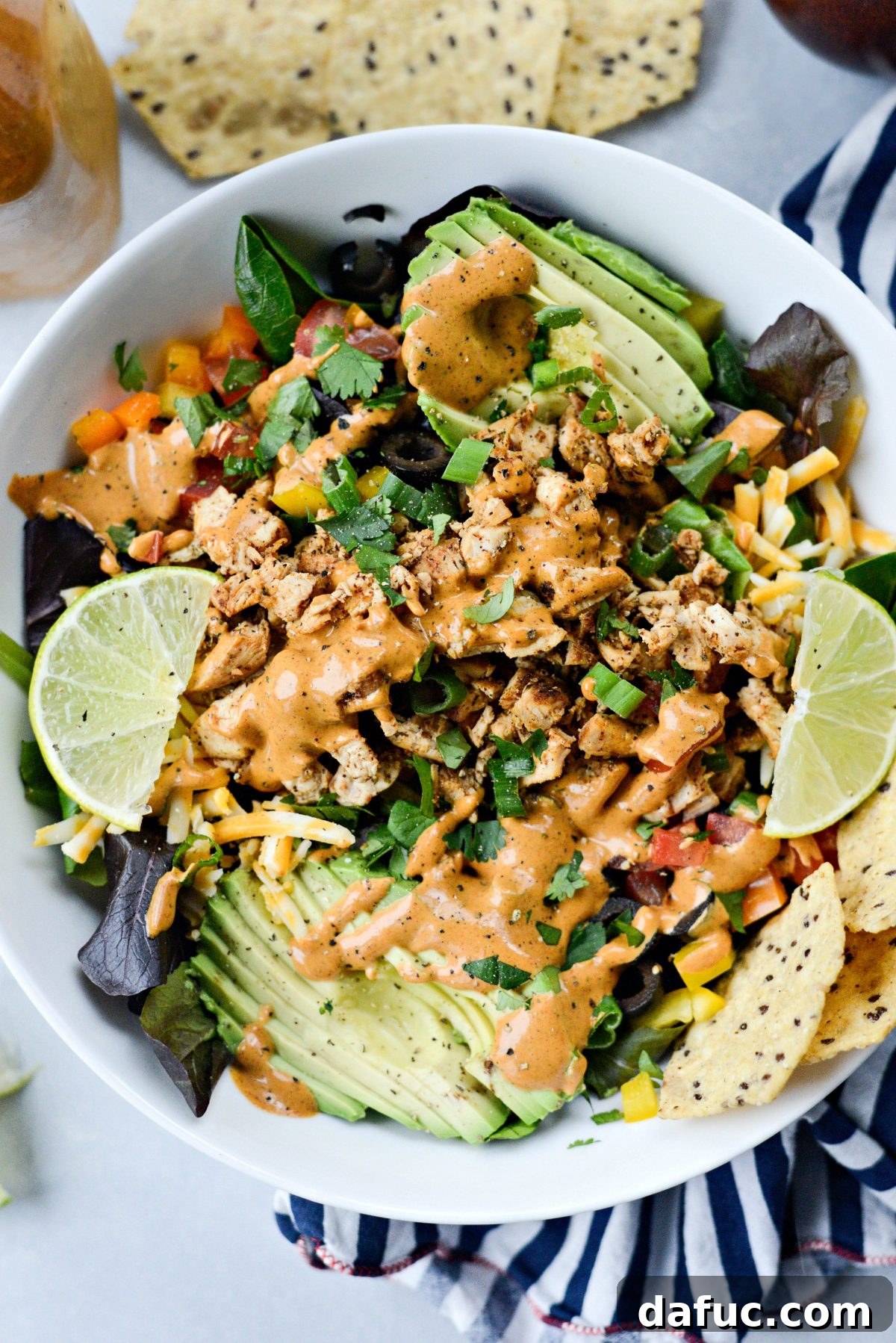 Creamy Homemade Southwest Dressing drizzled over a vibrant green salad
