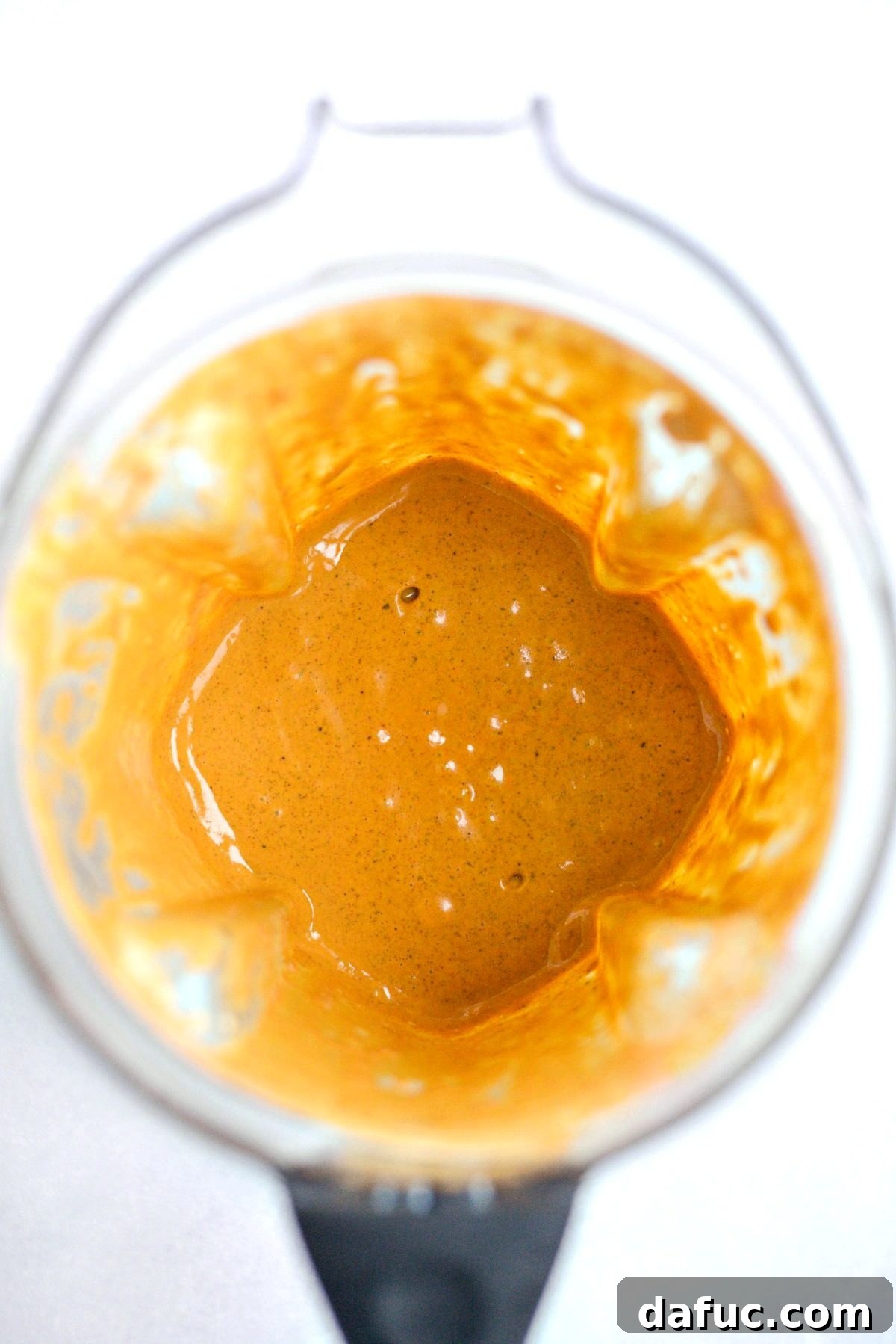 Close-up of creamy southwest dressing swirling inside a blender