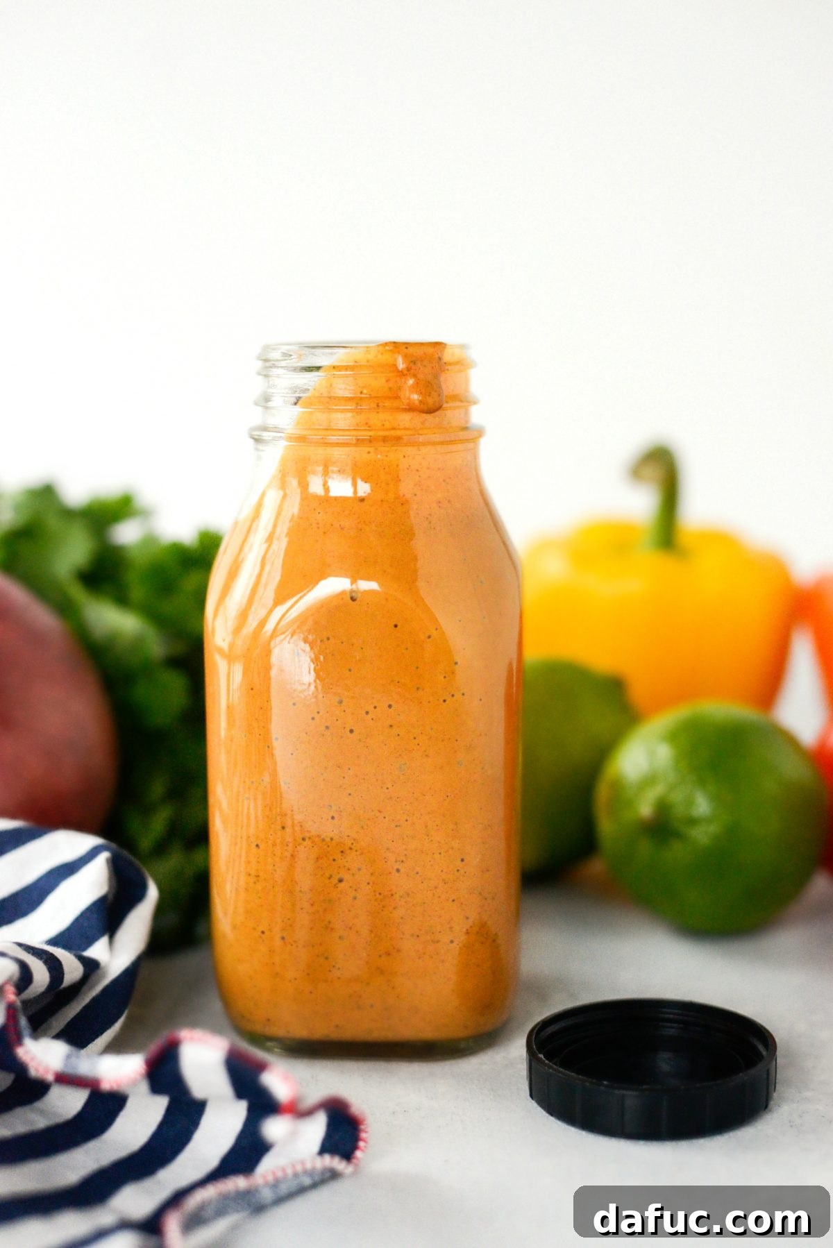 A full jar of Homemade Southwest Dressing on a rustic wooden table