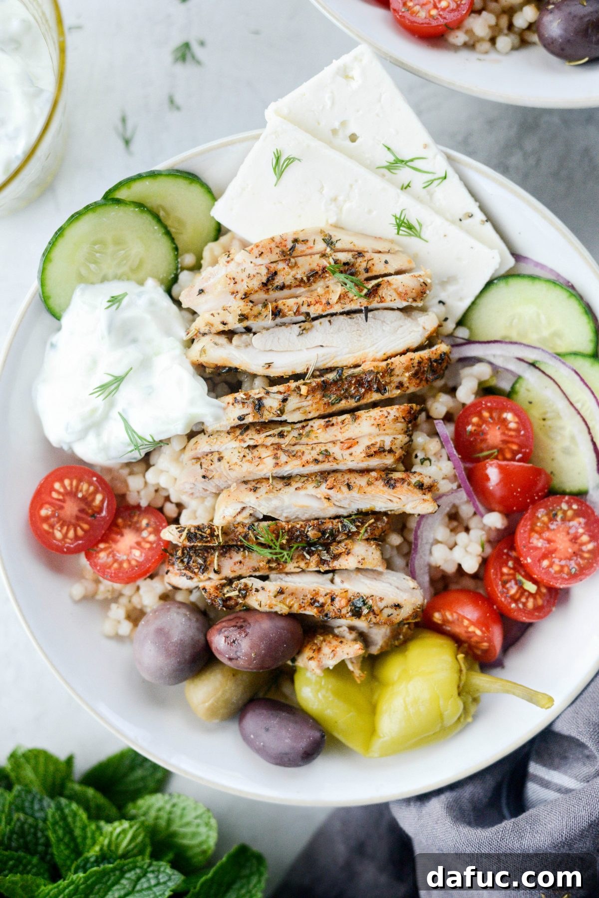 Vibrant Greek Chicken Couscous Bowl 2 Greek Chicken Couscous Bowl with fluffy couscous and roasted chicken