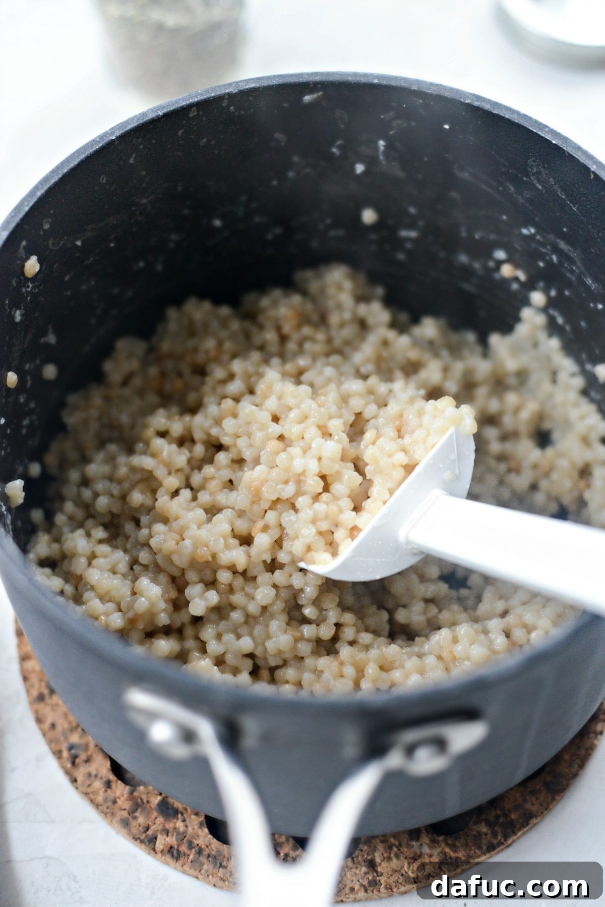Vibrant Greek Chicken Couscous Bowl 8 Cooked couscous, light and fluffy, in a bowl