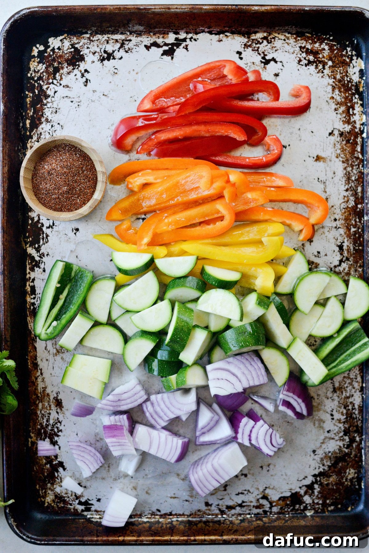 Vibrant Fajita Chicken Quinoa Prep Bowls 5 Preparing sliced bell peppers, zucchini, jalapeno, and red onion on a baking sheet