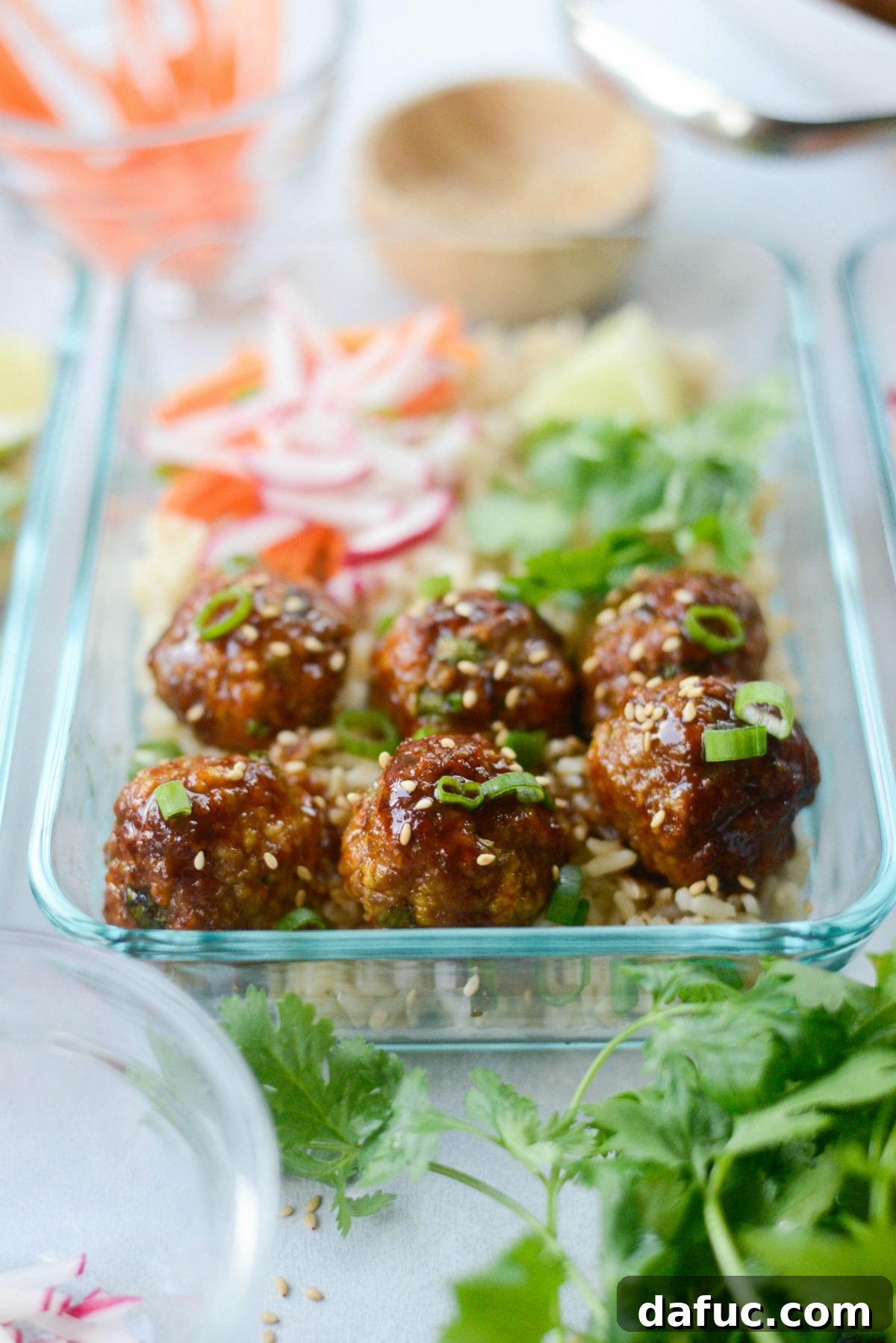 Delicious Maple Sriracha Glazed Meatballs served with brown rice and vegetables