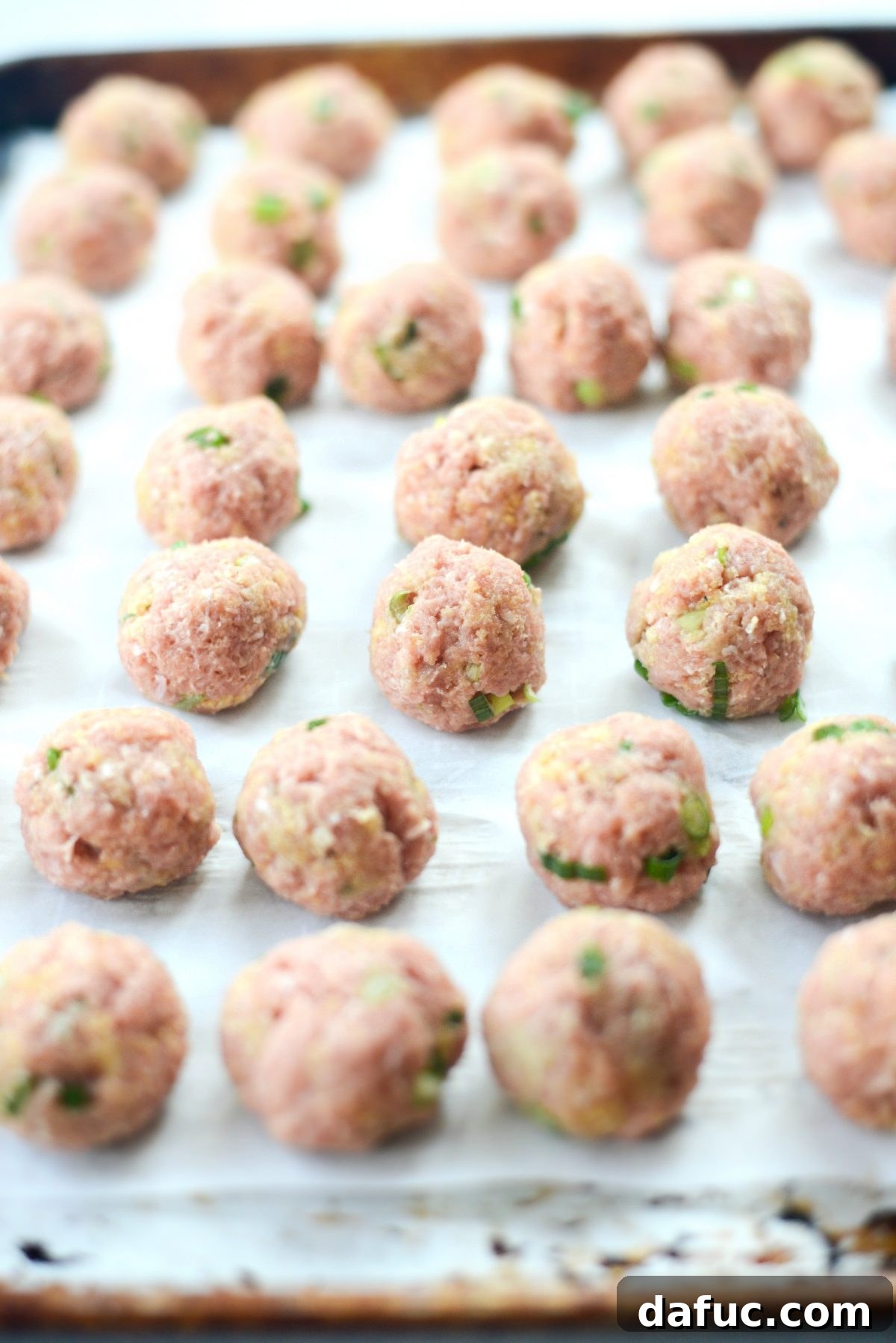 Meatball mixture being stirred with a fork