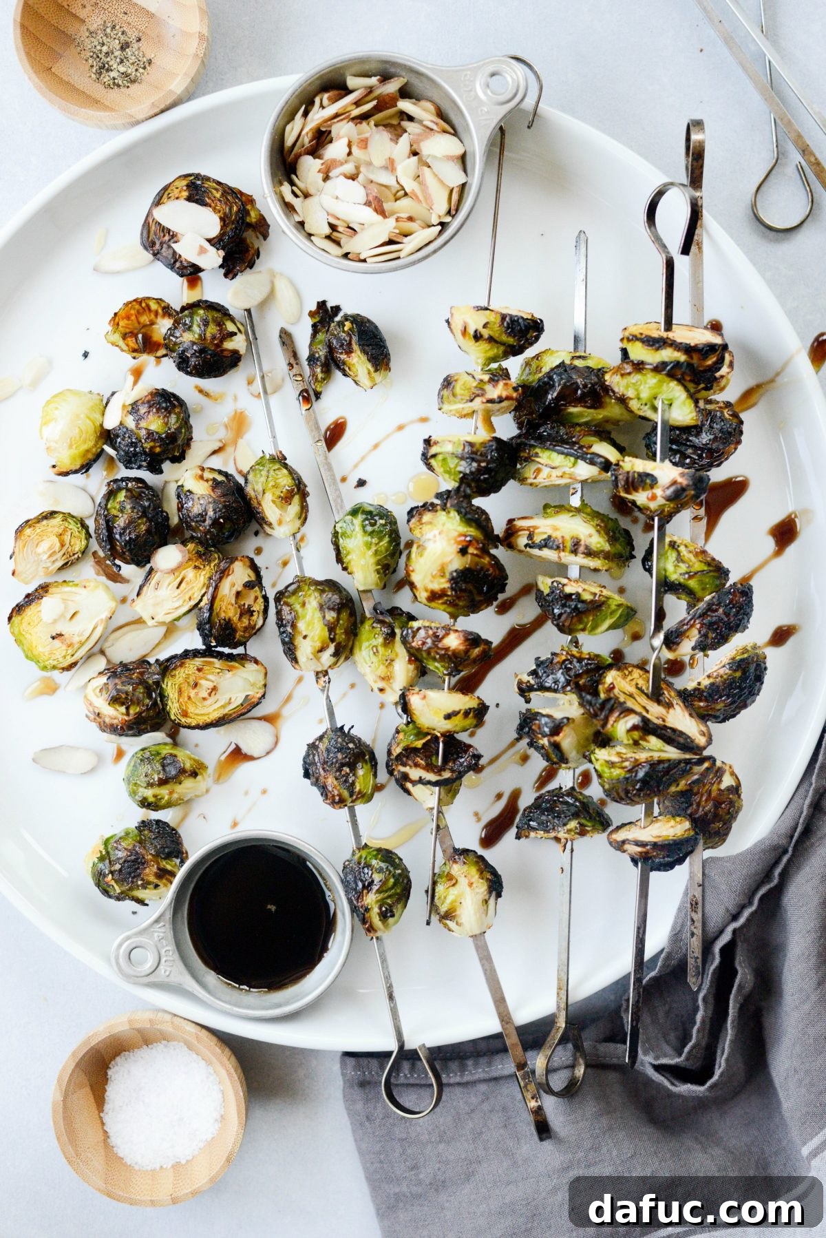 Close-up of a single Grilled Garlic Brussels Sprout showing the char and tender interior