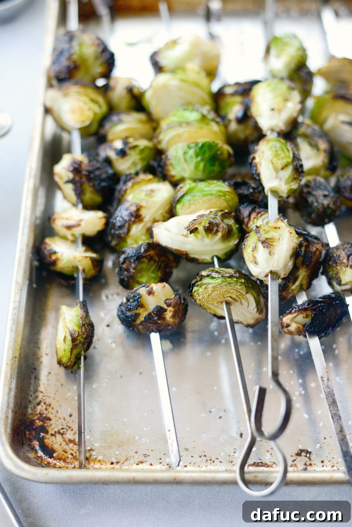 Grilled Garlic Brussels Sprouts cooking on the grill grates