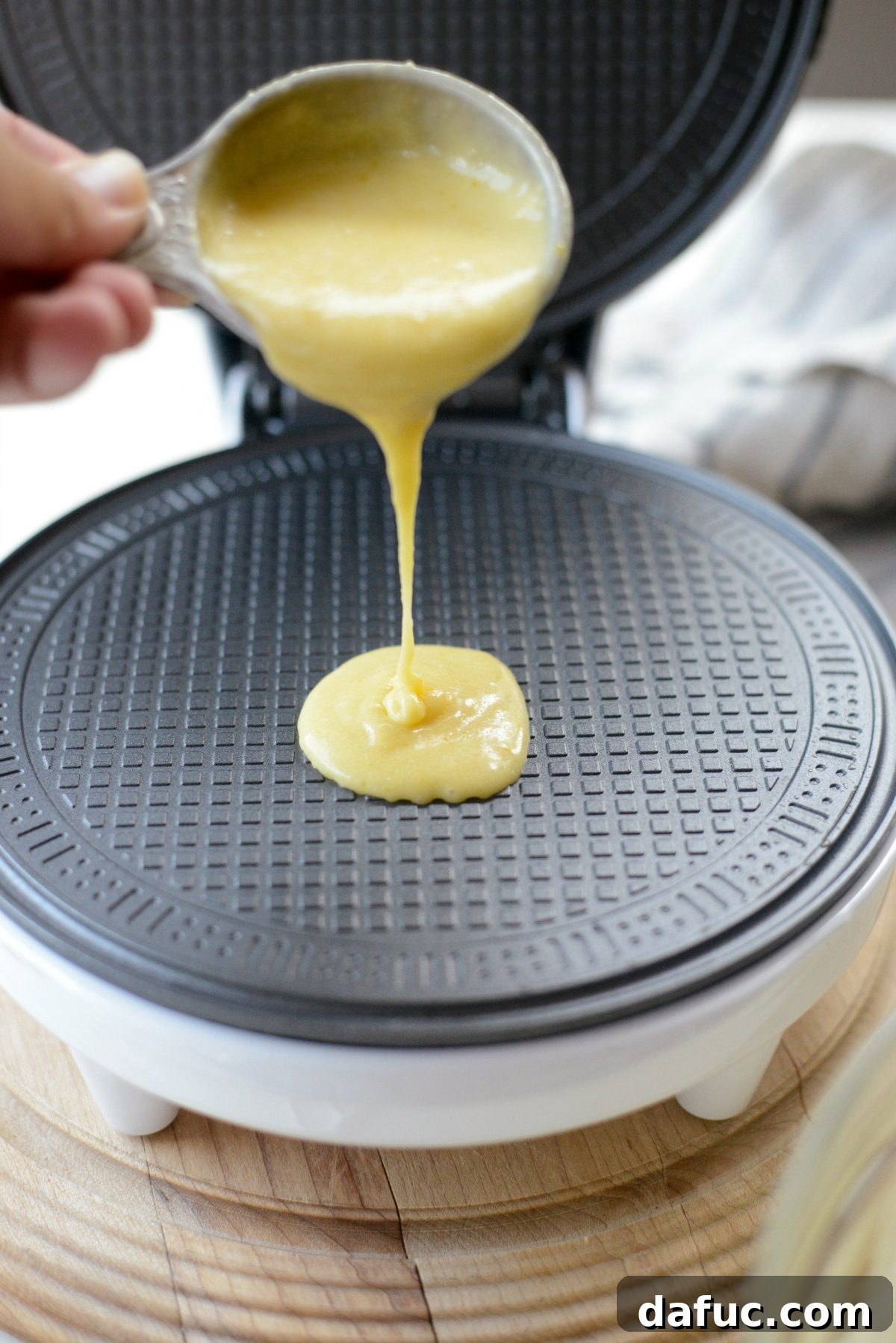 Pouring batter onto a waffle bowl or cone maker