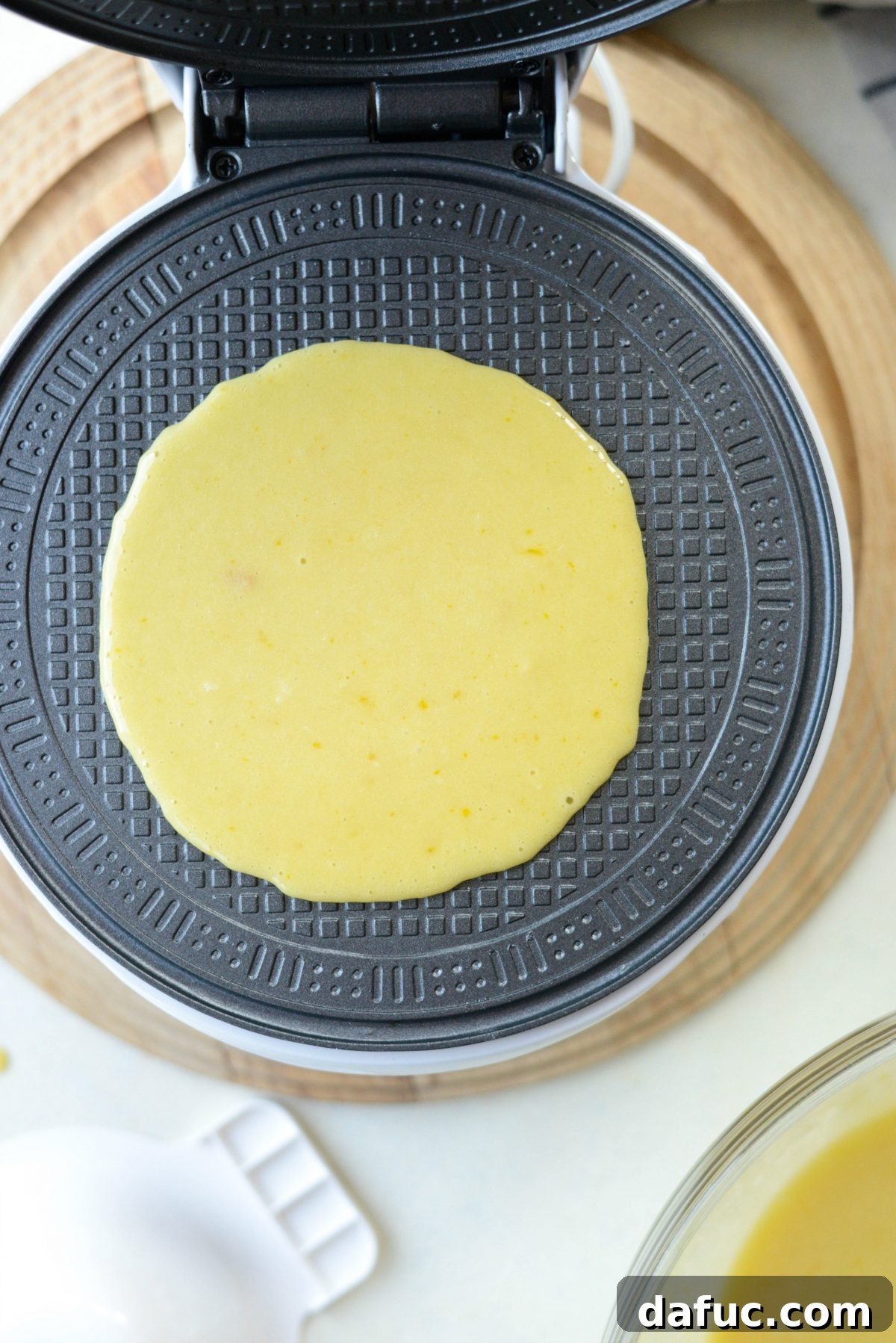 Waffle batter on a hot waffle iron