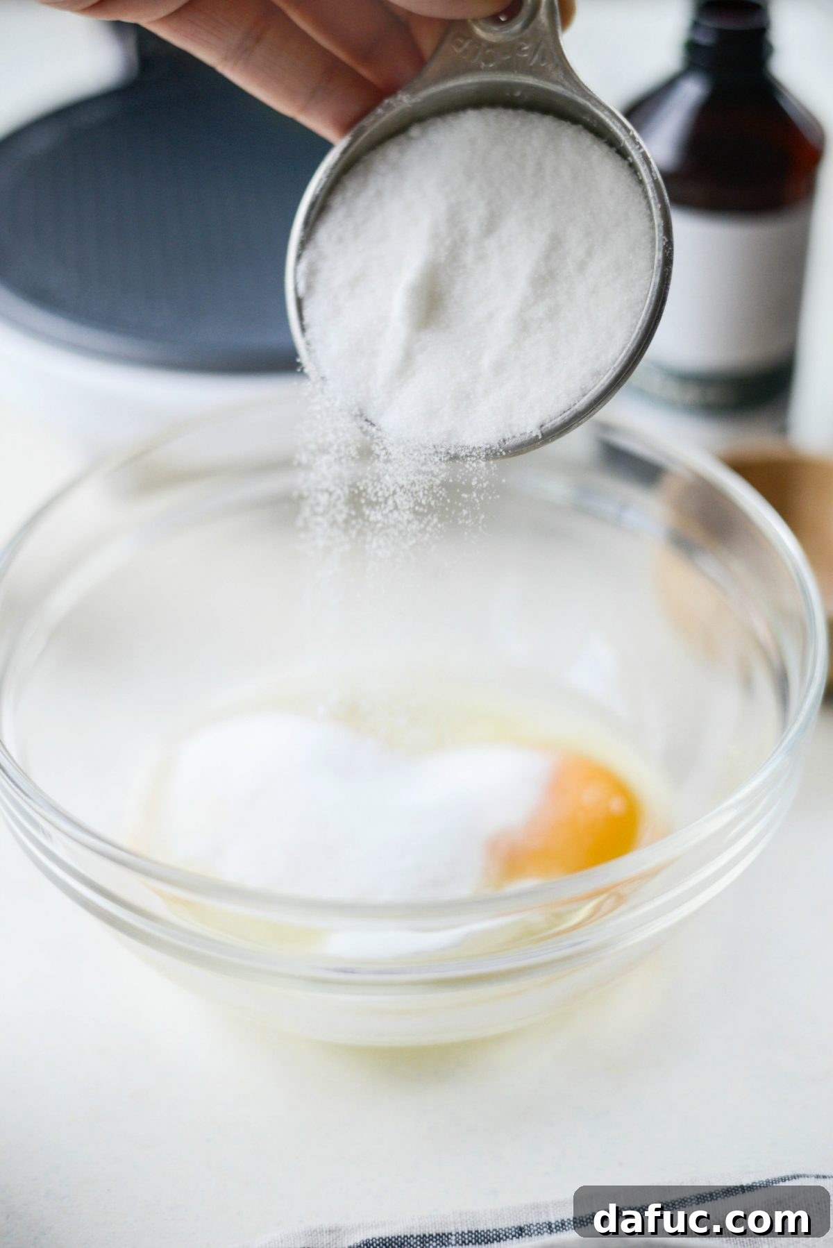 Adding sugar to eggs for waffle bowl batter