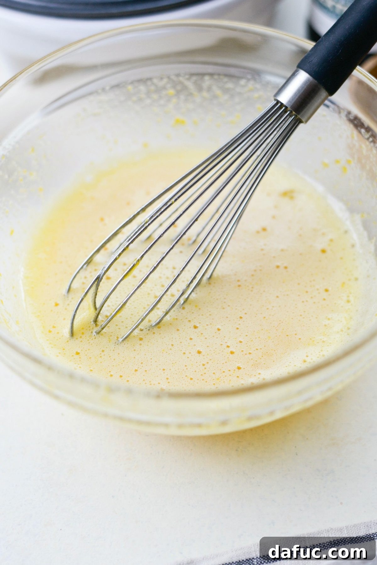 Whisking eggs and sugar until frothy