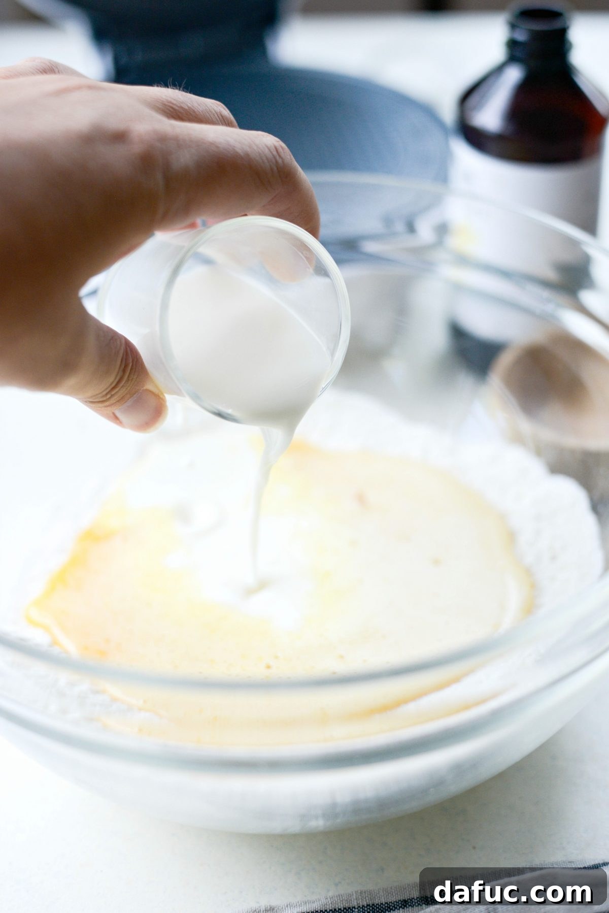 Pouring milk into the wet ingredients