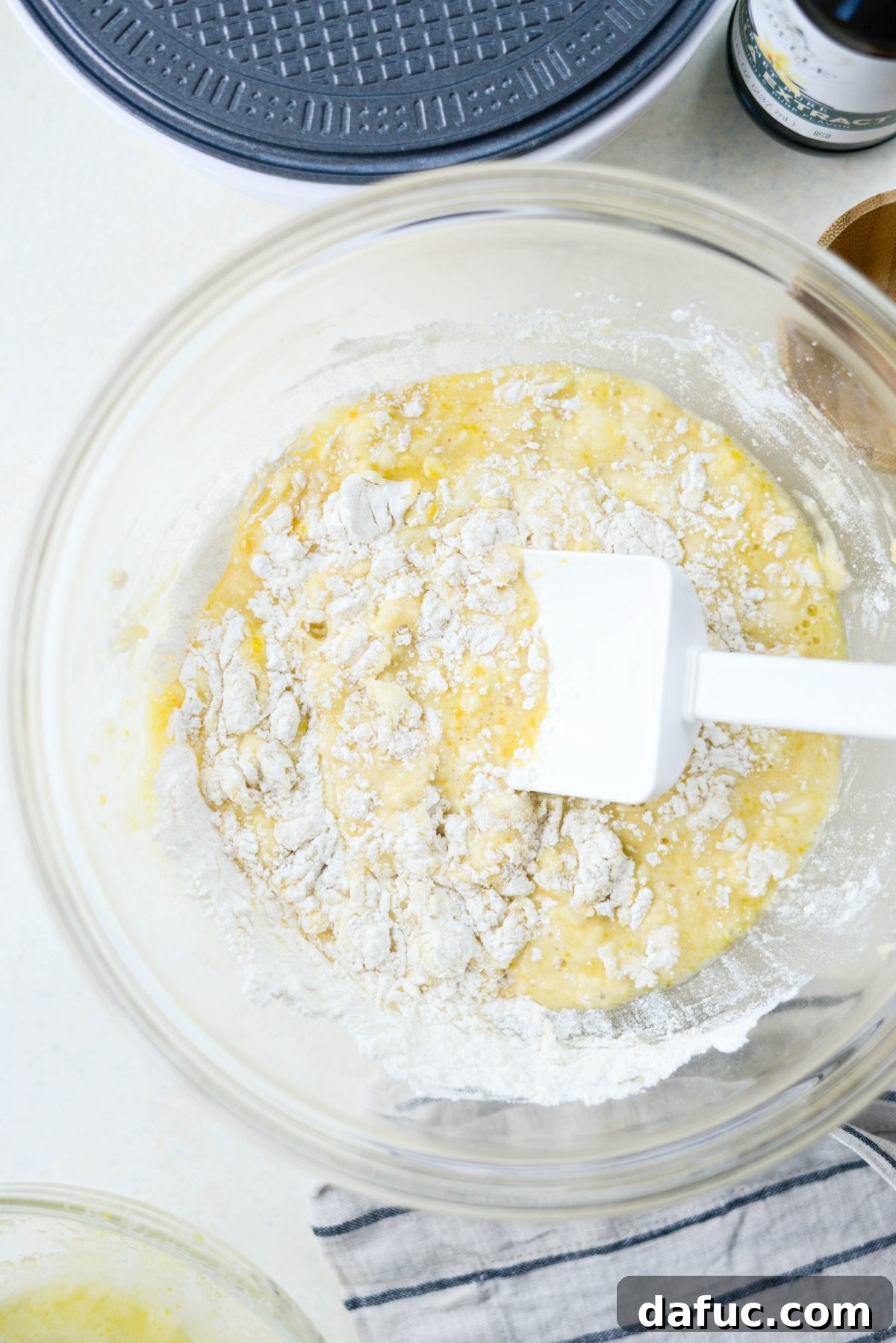 Stirring wet ingredients into the dry mixture