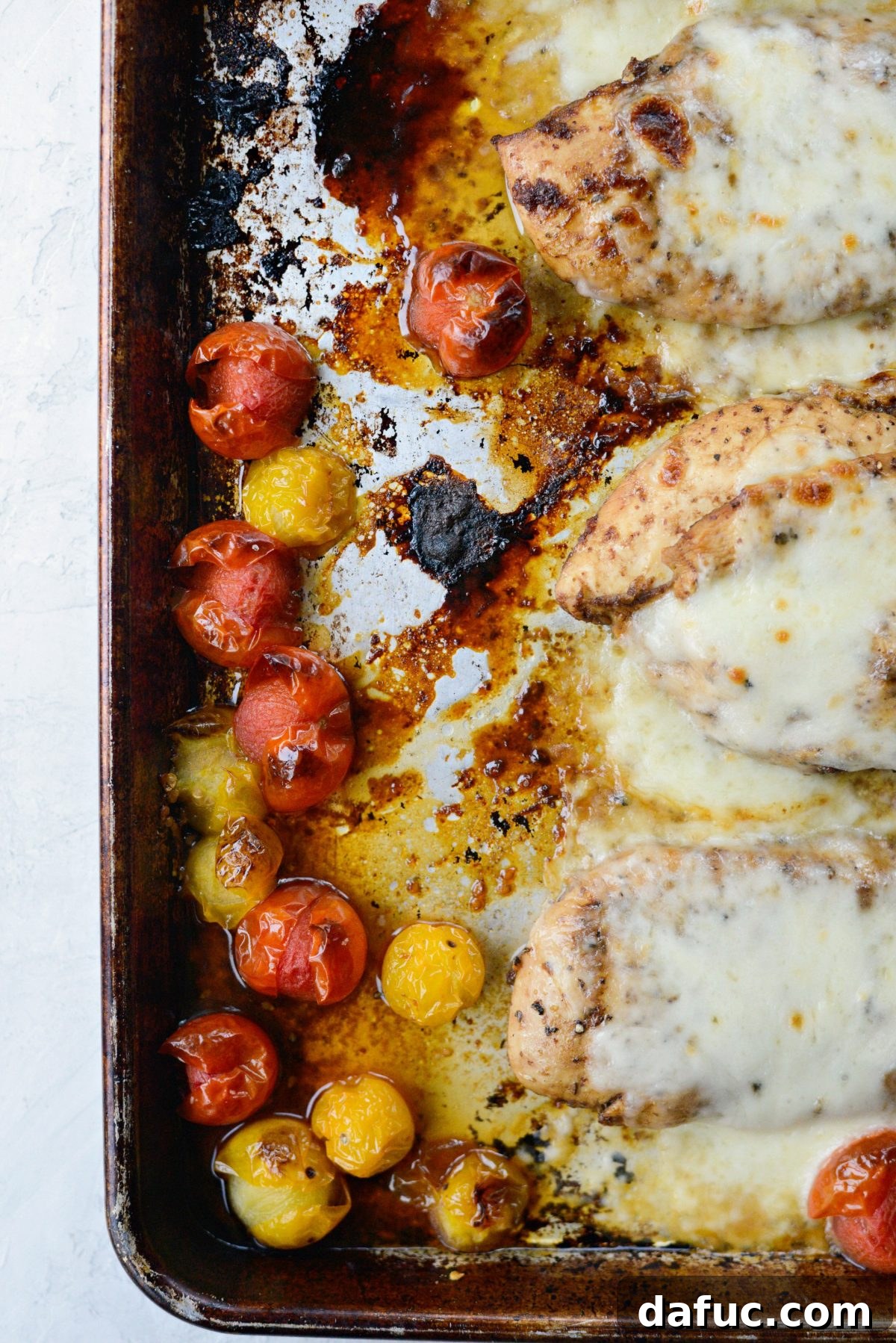 Close-up of perfectly burst cherry tomatoes and pan sauce