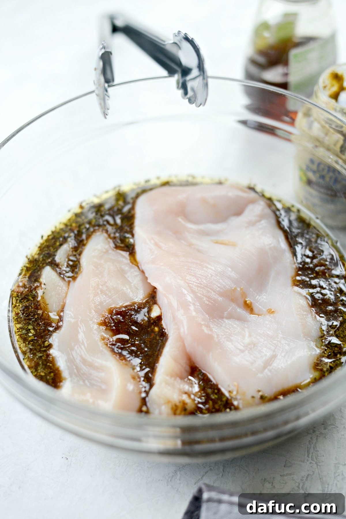 Adding chicken breasts to the balsamic basil marinade