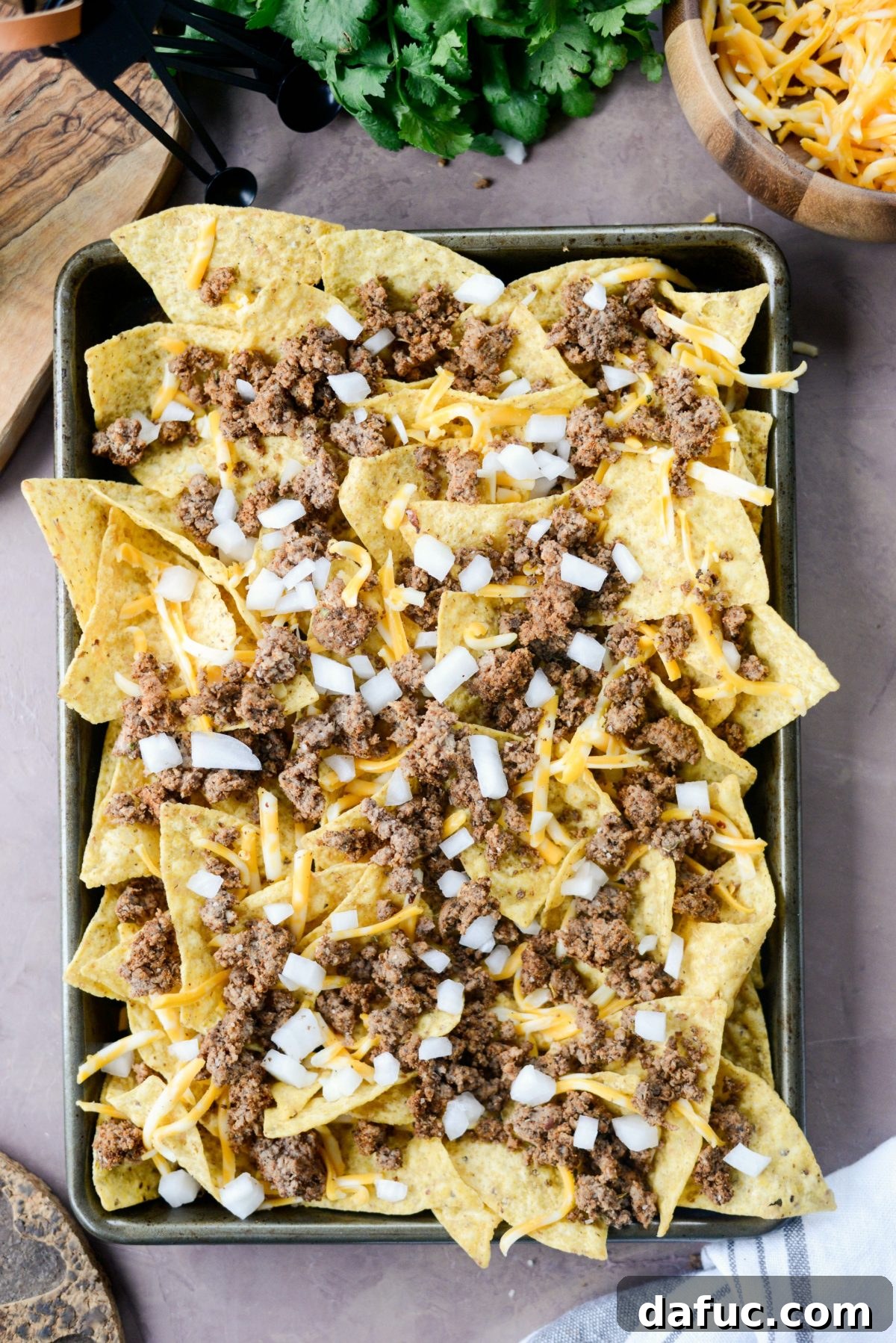 Ultimate Taco Nachos 8 add some cheese, meat and onions