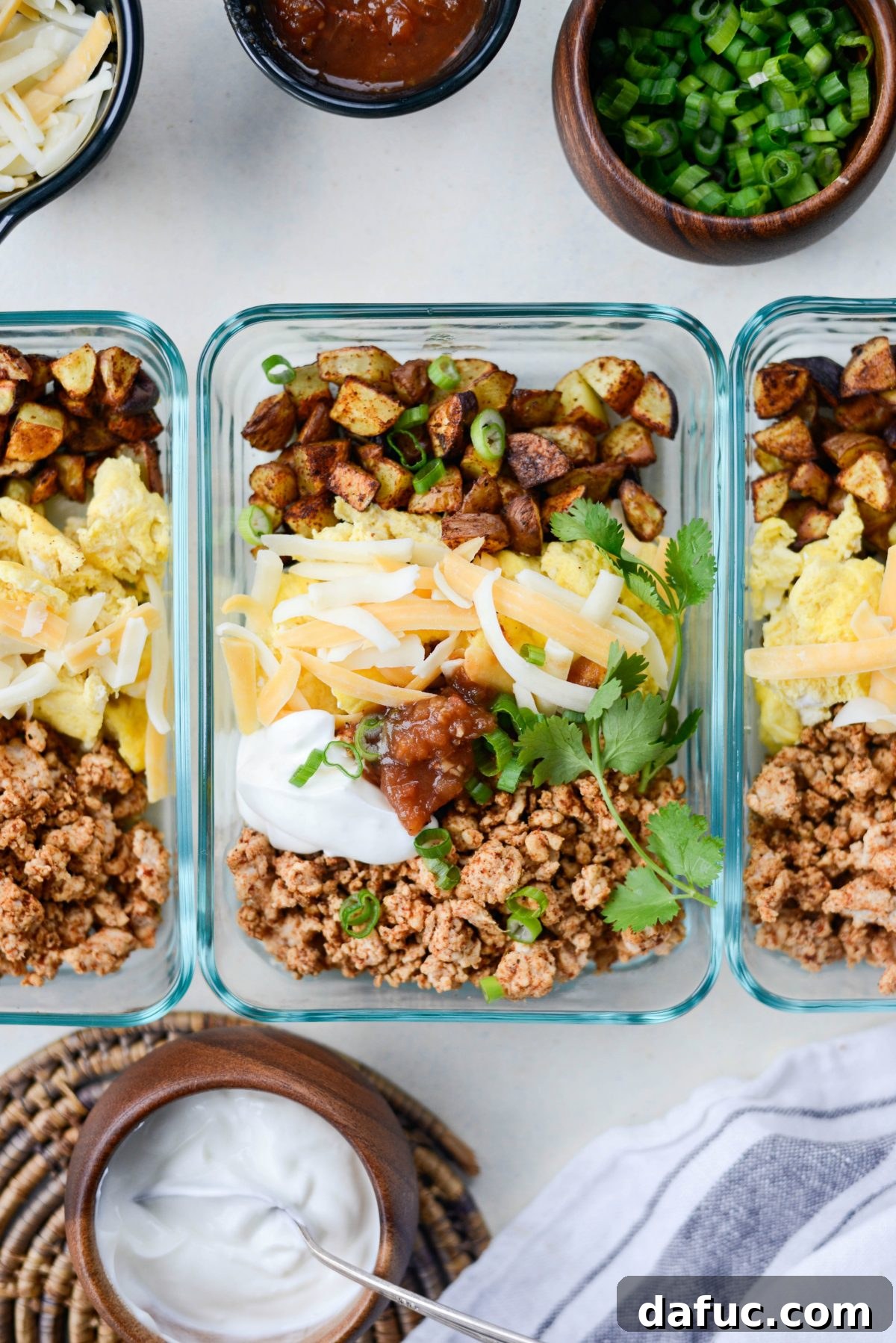 Easy Turkey Taco Breakfast Scramble Meal Prep 2 Delicious Turkey Taco Breakfast Scramble in a meal prep container, garnished with fresh cilantro and green onions, ready for a healthy start to the day.