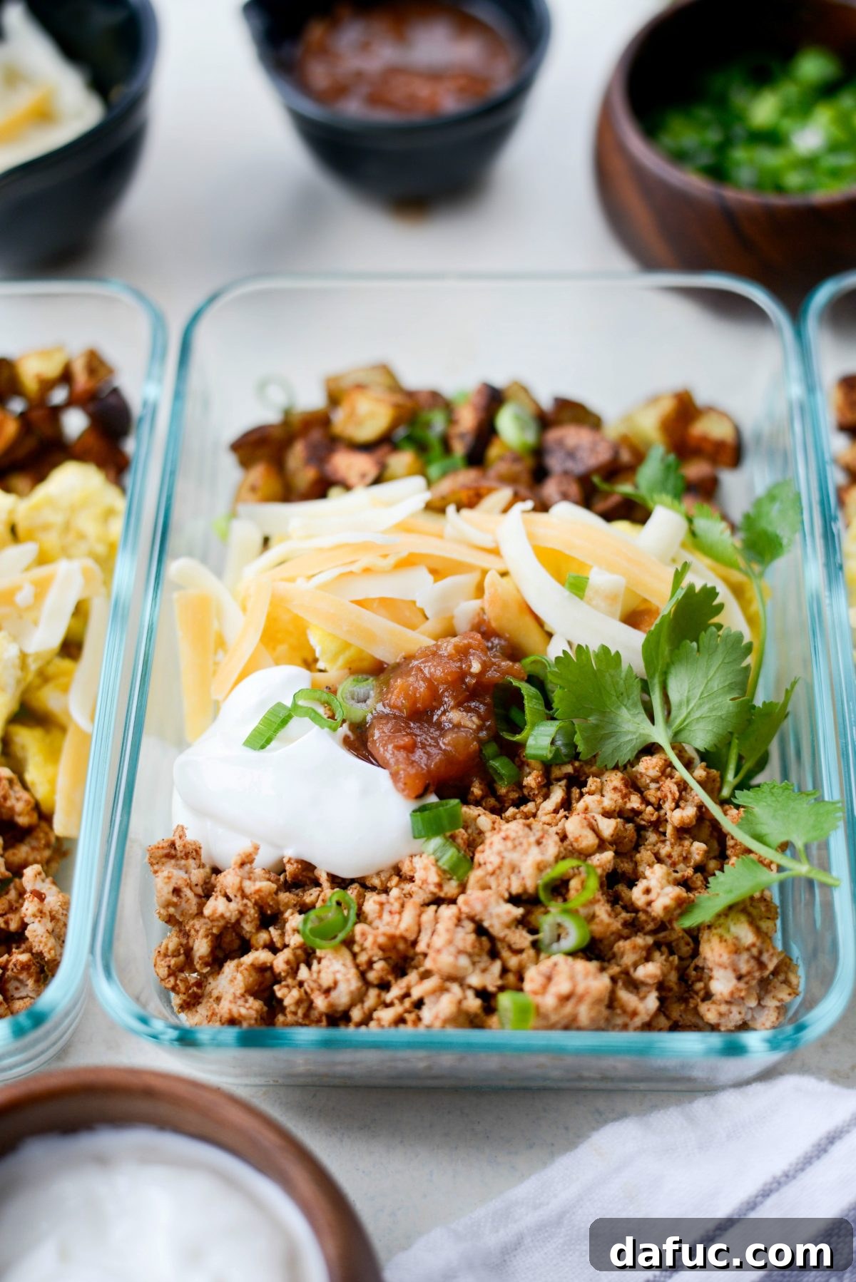 Easy Turkey Taco Breakfast Scramble Meal Prep 3 Overhead shot of Turkey Taco Breakfast Scramble in a glass meal prep container, showcasing the vibrant ingredients.