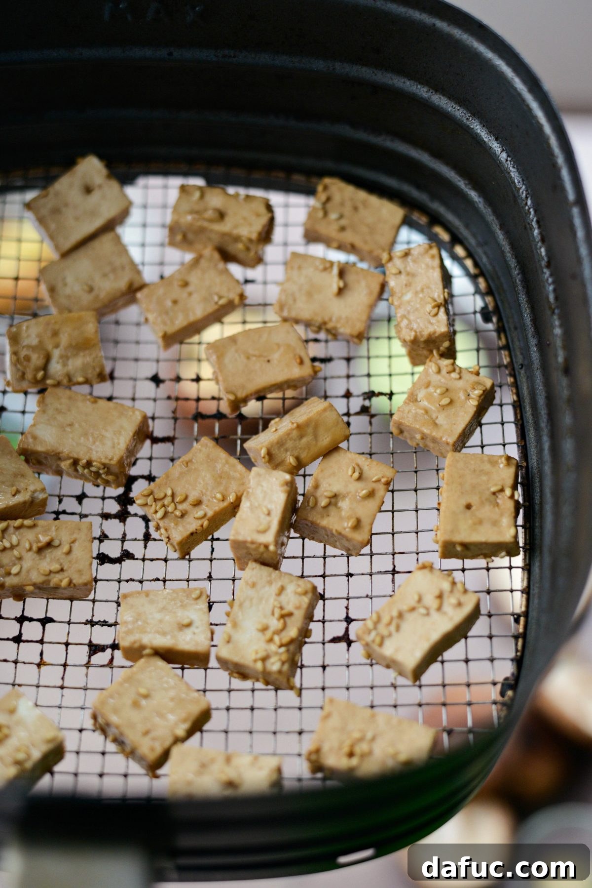 Perfectly Crispy Air Fryer Tofu with Creamy Peanut Sauce 8 Tofu in air fryer basket