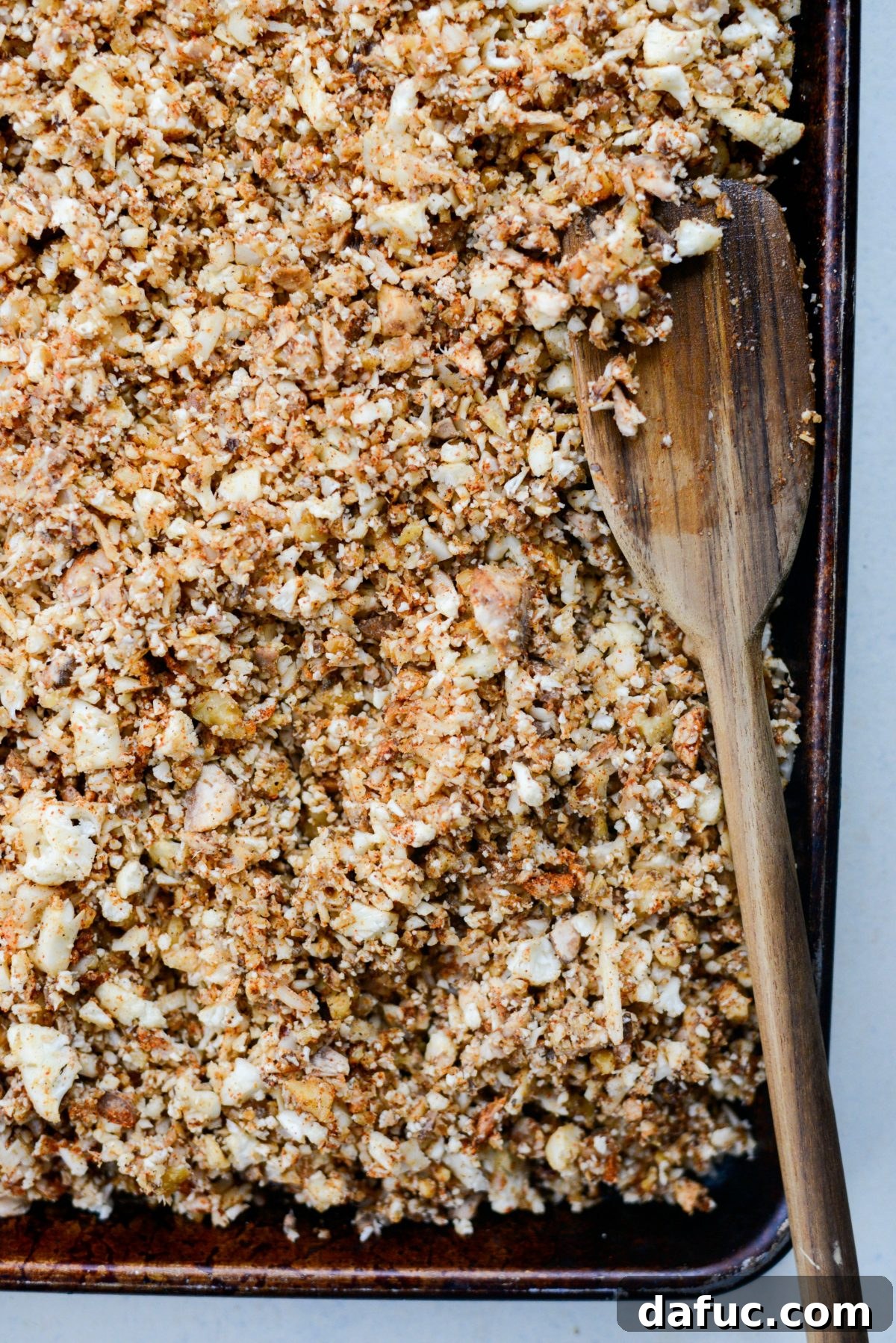 Spiced Cauliflower Taco Crumble 13 Dividing and spreading vegan taco meat mixture onto two baking sheets for roasting