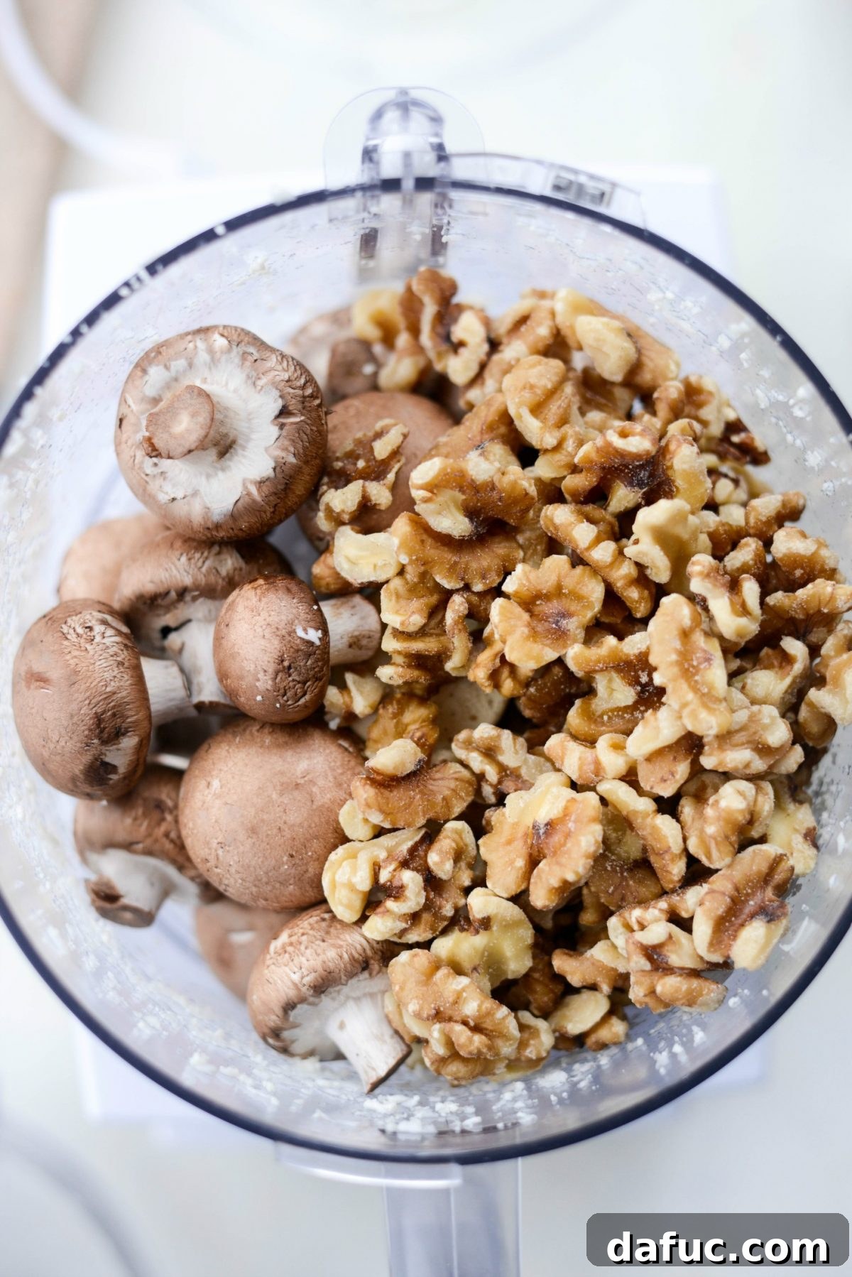 Spiced Cauliflower Taco Crumble 7 Cremini mushrooms and walnuts being pulsed in a food processor