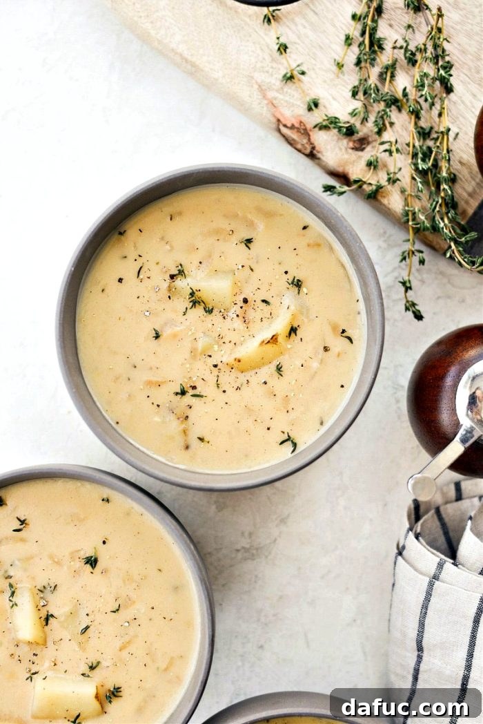 Creamy French Onion Chowder 2 Rich and creamy French Onion Chowder in a bowl, garnished with fresh thyme