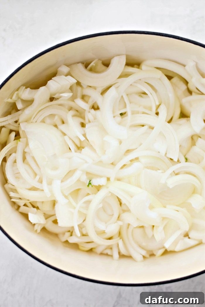 Creamy French Onion Chowder 7 Adding sliced onions to melted butter and olive oil in a pot