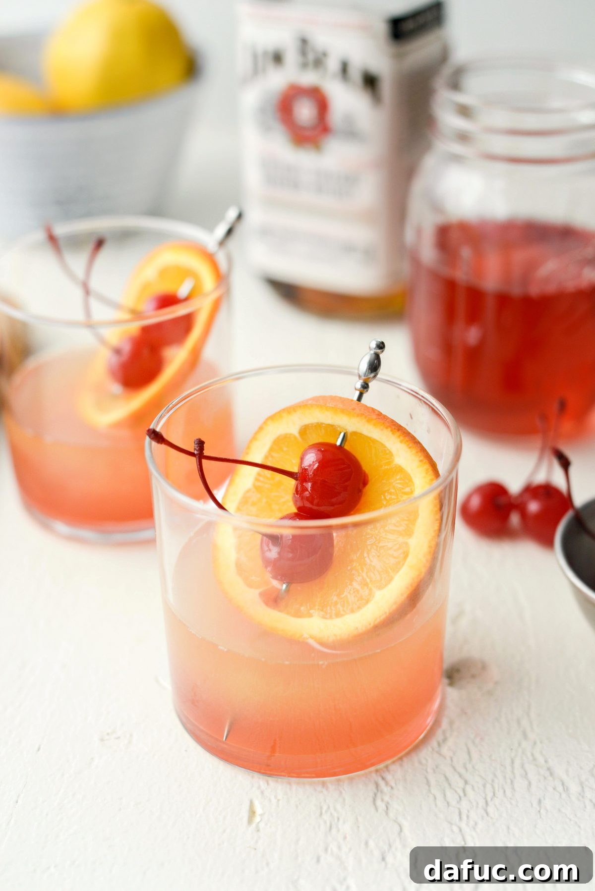 Golden Glow Whiskey Sour 2 Whiskey Sour Sunrise with two cherries