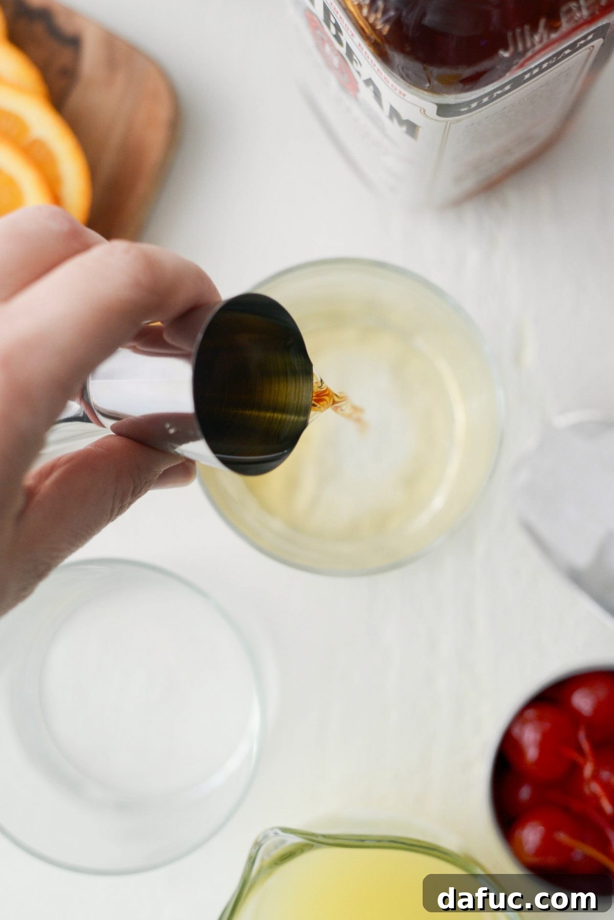 Golden Glow Whiskey Sour 6 pouring whiskey