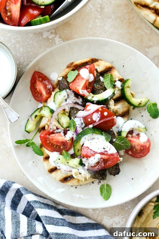 Delicious and flavorful Lamb Kofta Open-Faced Pita Sandwiches arranged on a platter