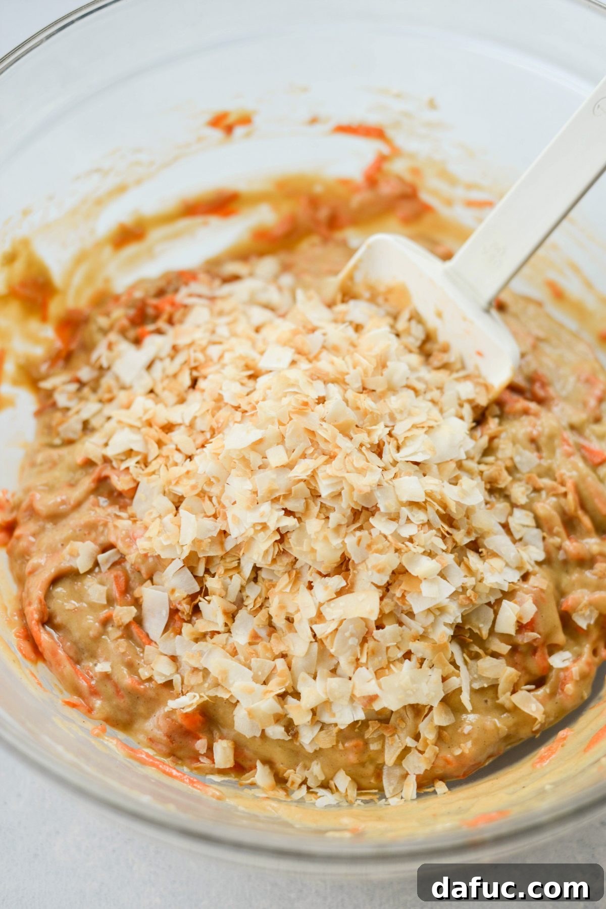 Warmly Spiced Coconut Chai Carrot Cake with Mascarpone Frosting 11 Add toasted coconut to batter.
