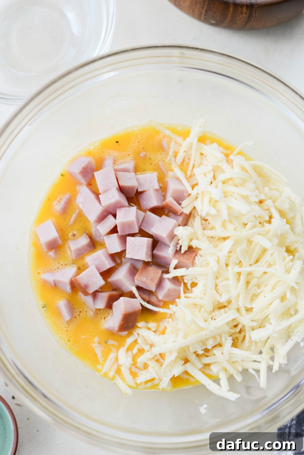 Wholesome Ham, Swiss and Broccoli Quiche 13 Adding diced ham and grated Swiss cheese to the whisked eggs