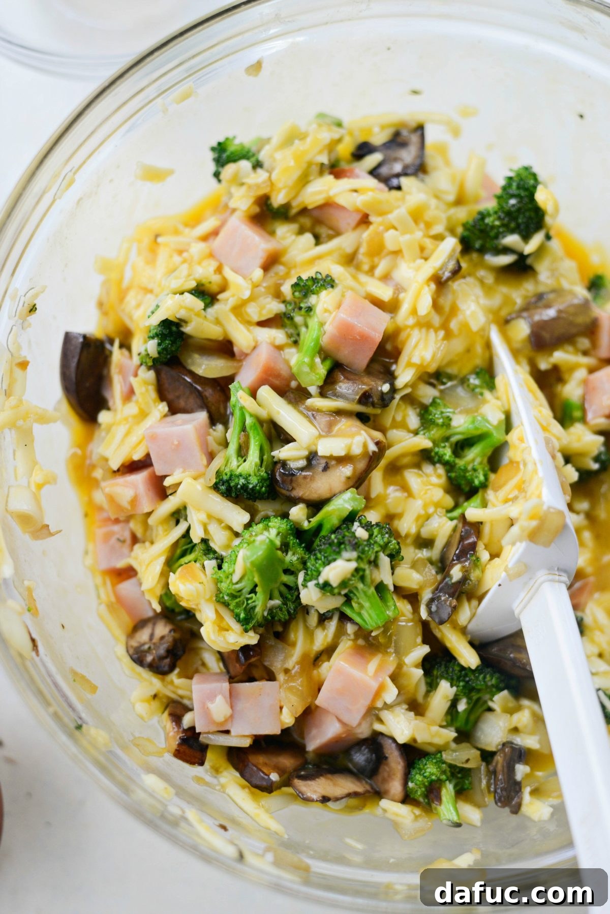 Wholesome Ham, Swiss and Broccoli Quiche 15 Stirring the quiche mixture to incorporate all ingredients evenly