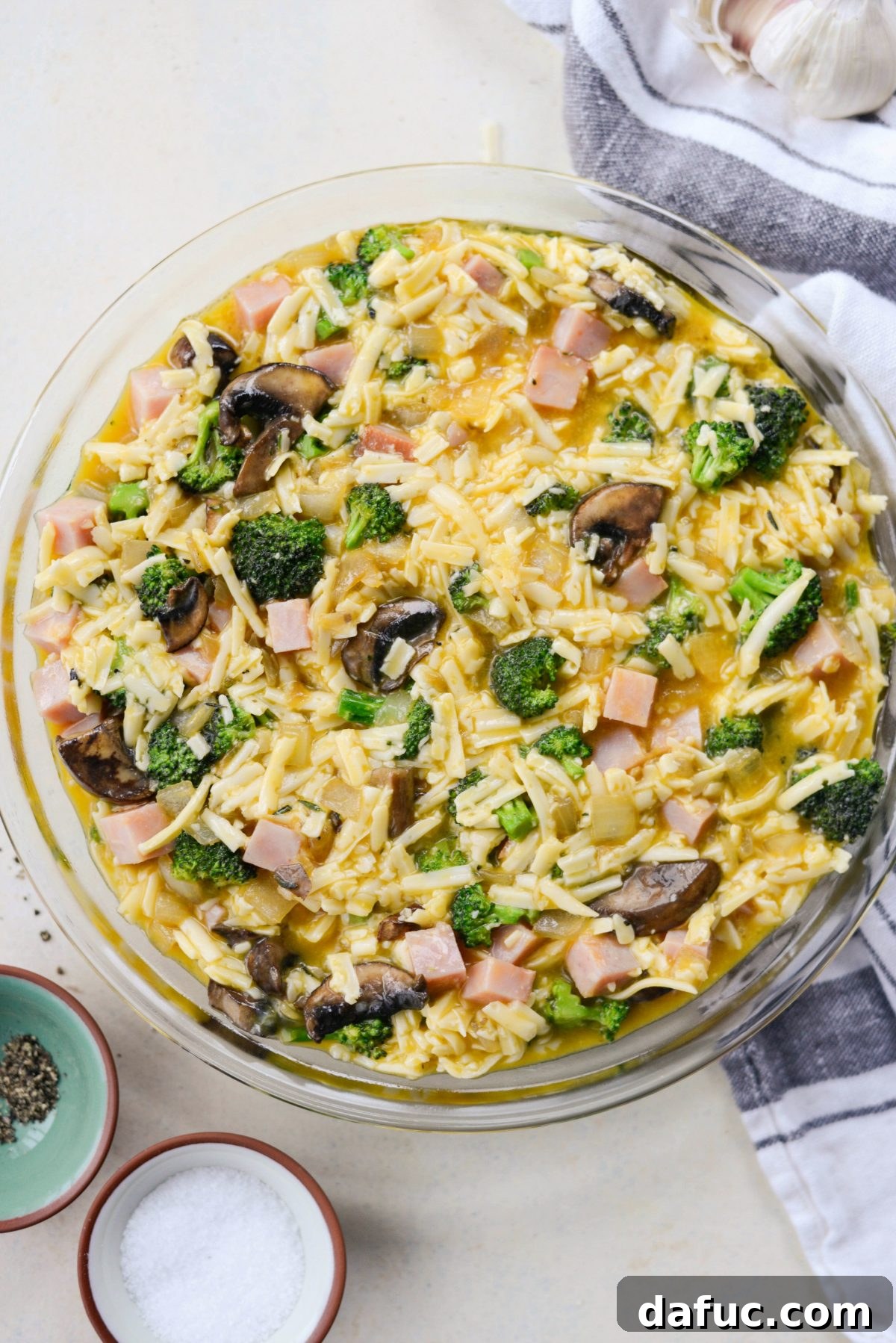 Wholesome Ham, Swiss and Broccoli Quiche 16 Pouring the quiche egg mixture into a greased pie dish