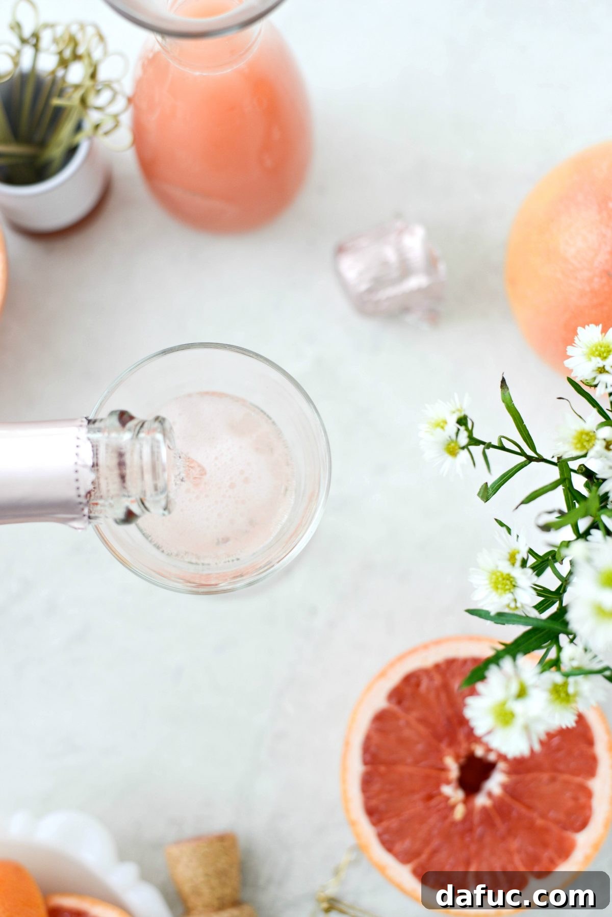Effervescent Rosé Grapefruit Delight 5 Pouring rosé sparkling wine into a glass