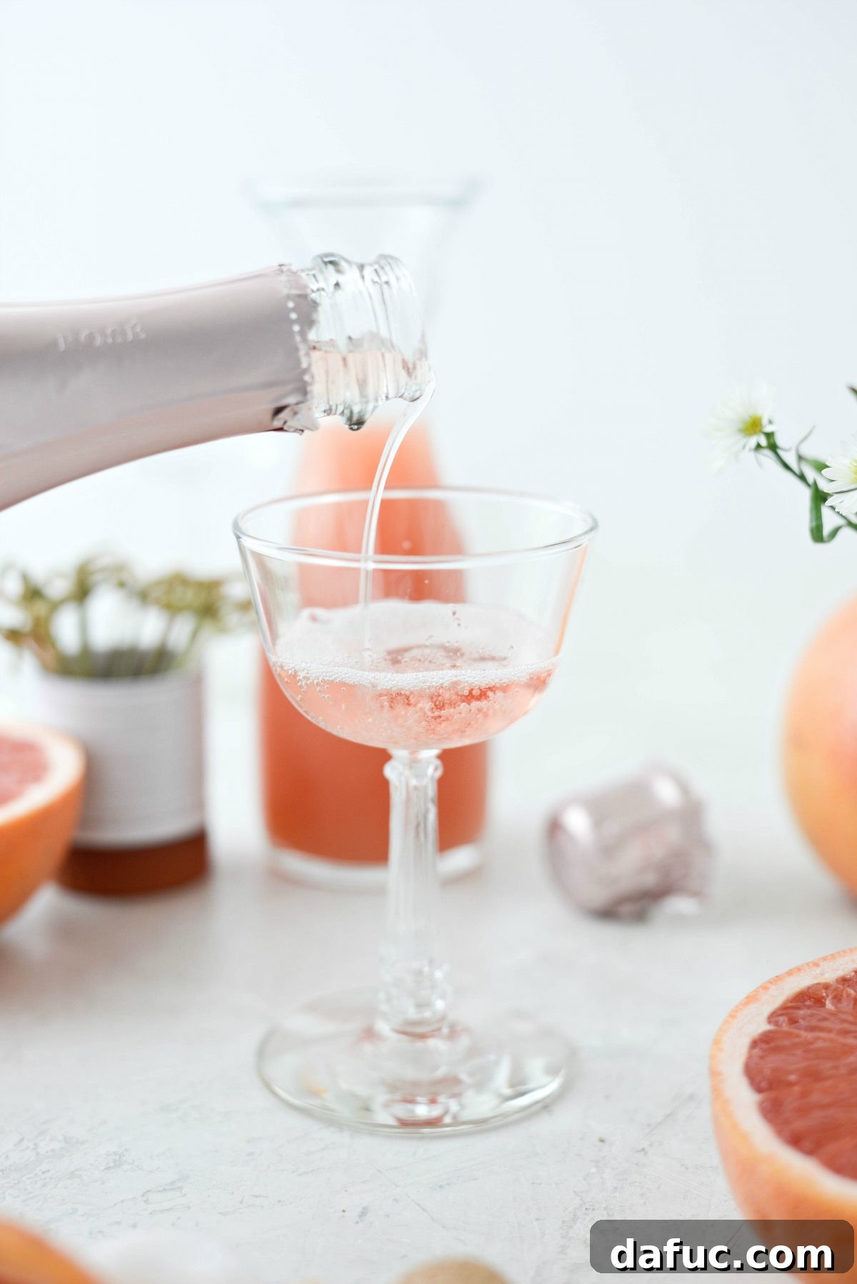 Effervescent Rosé Grapefruit Delight 6 Carefully adding rosé champagne to the serving glass