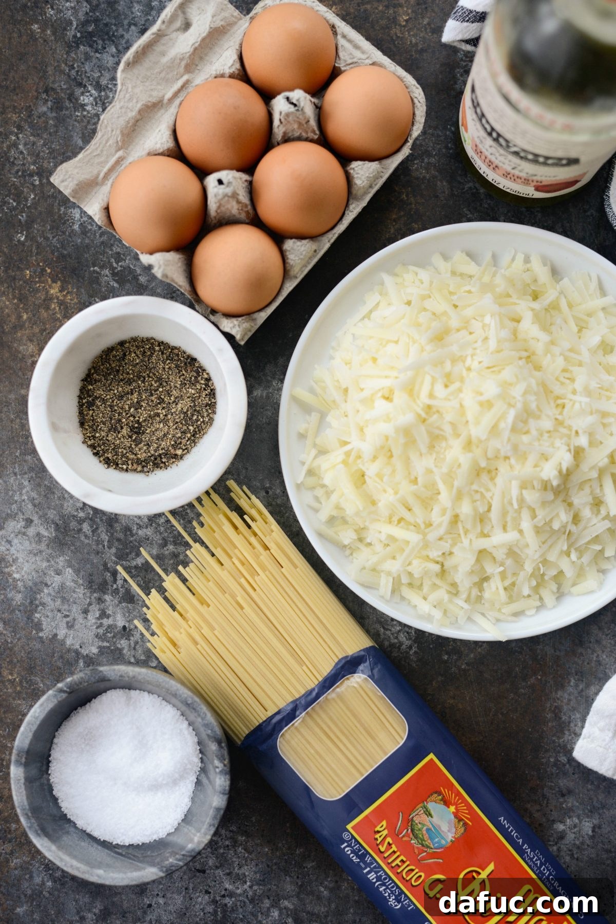 Reimagined Cacio e Pepe Carbonara 4 Key ingredients for Cacio e Pepe Carbonara: spaghetti, eggs, a block of Pecorino Romano cheese, and black peppercorns.