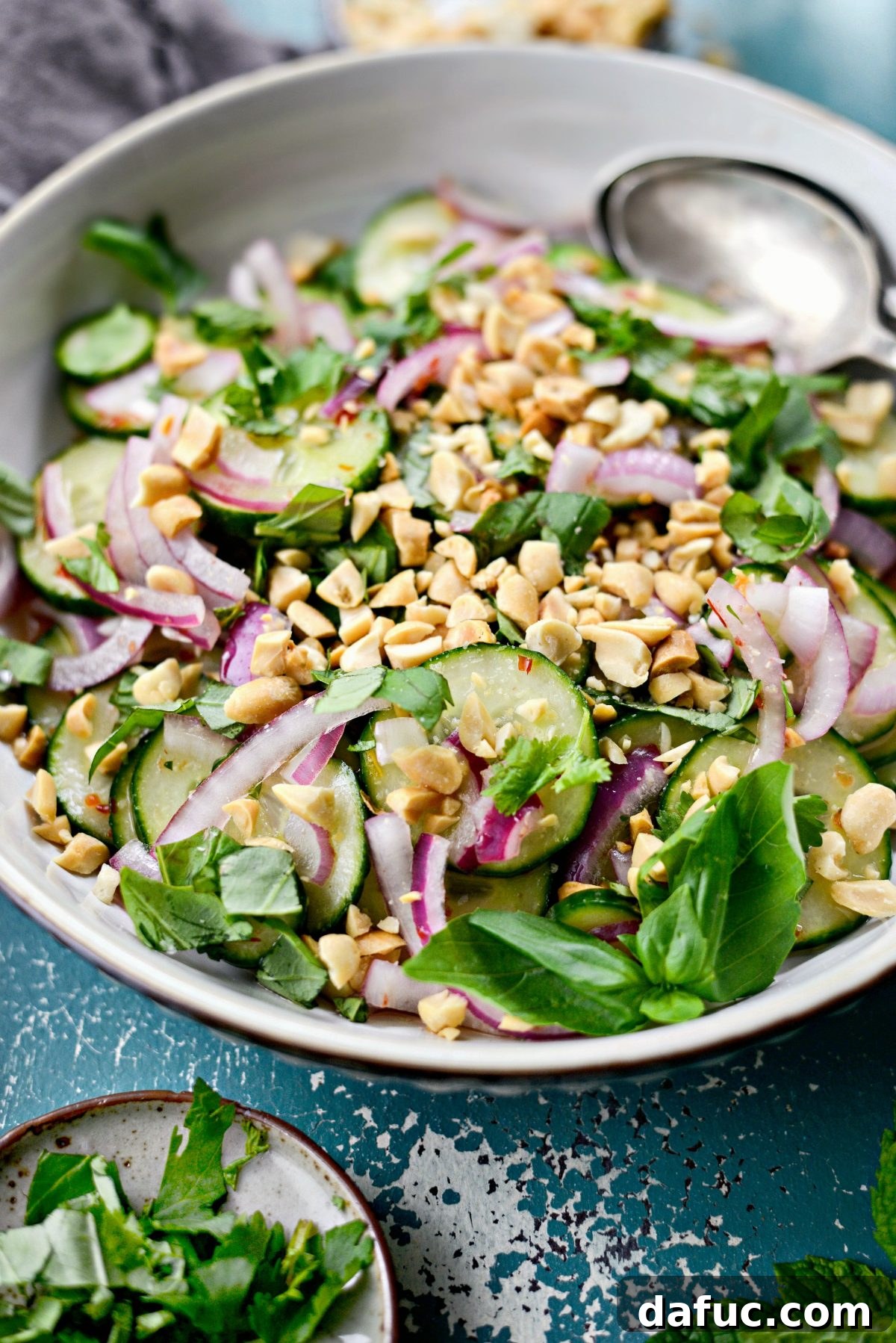 Close-up of a bowl of vibrantly colored Thai Cucumber Salad