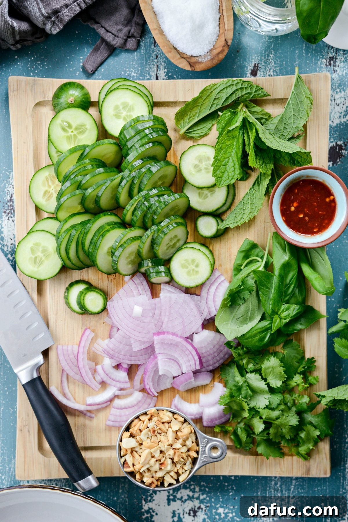 Fresh ingredients like cucumbers, onions, and herbs prepared for the salad