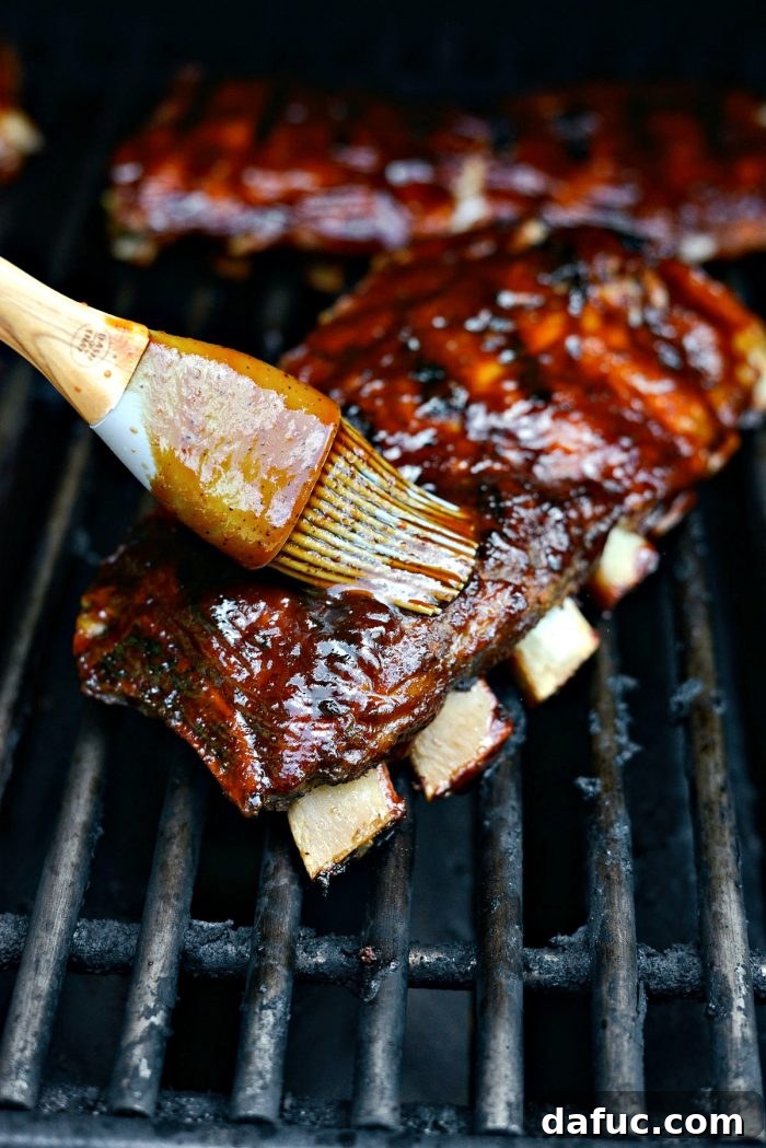 Flipping and brushing ribs on the grill for perfect caramelization