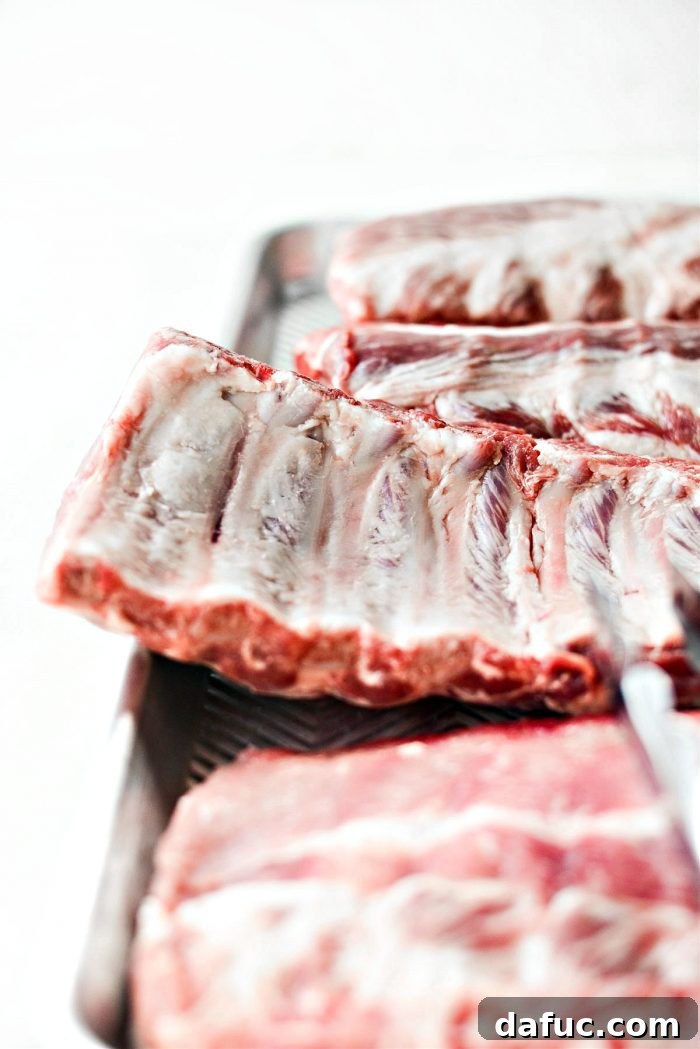 Demonstration of removing silver skin from baby back ribs
