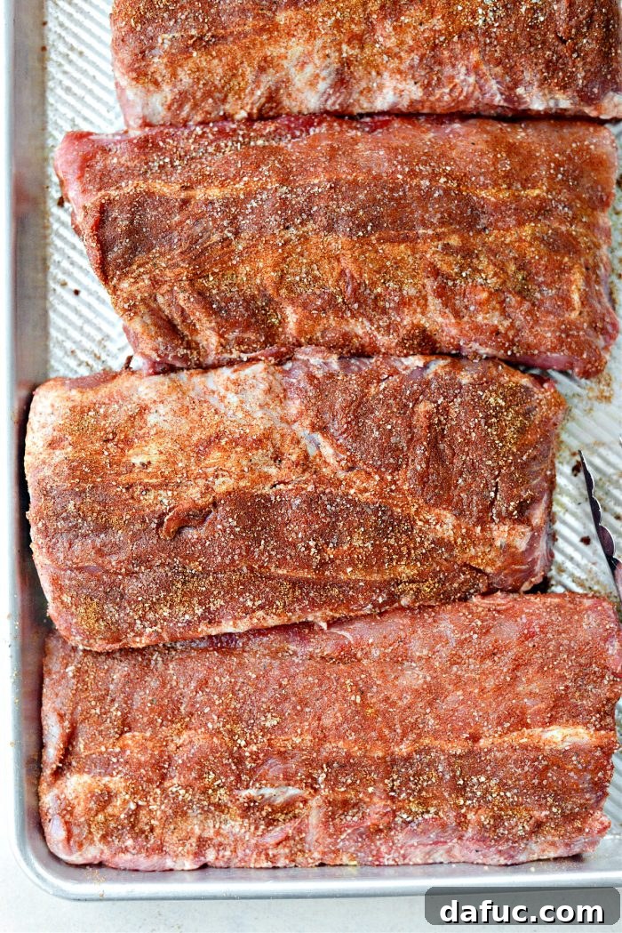 Applying dry rub to both sides of the ribs