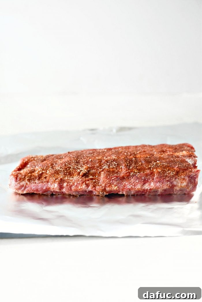Rubbed ribs placed on aluminum foil for baking