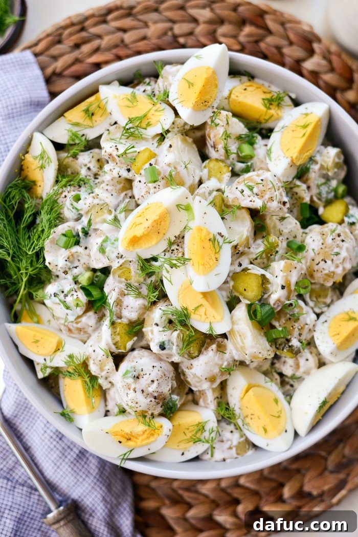 Pucker-Up Potato Salad 2 Delicious Dill Pickle Potato Salad with fresh dill and black pepper garnish, perfect for summer potlucks and cookouts.