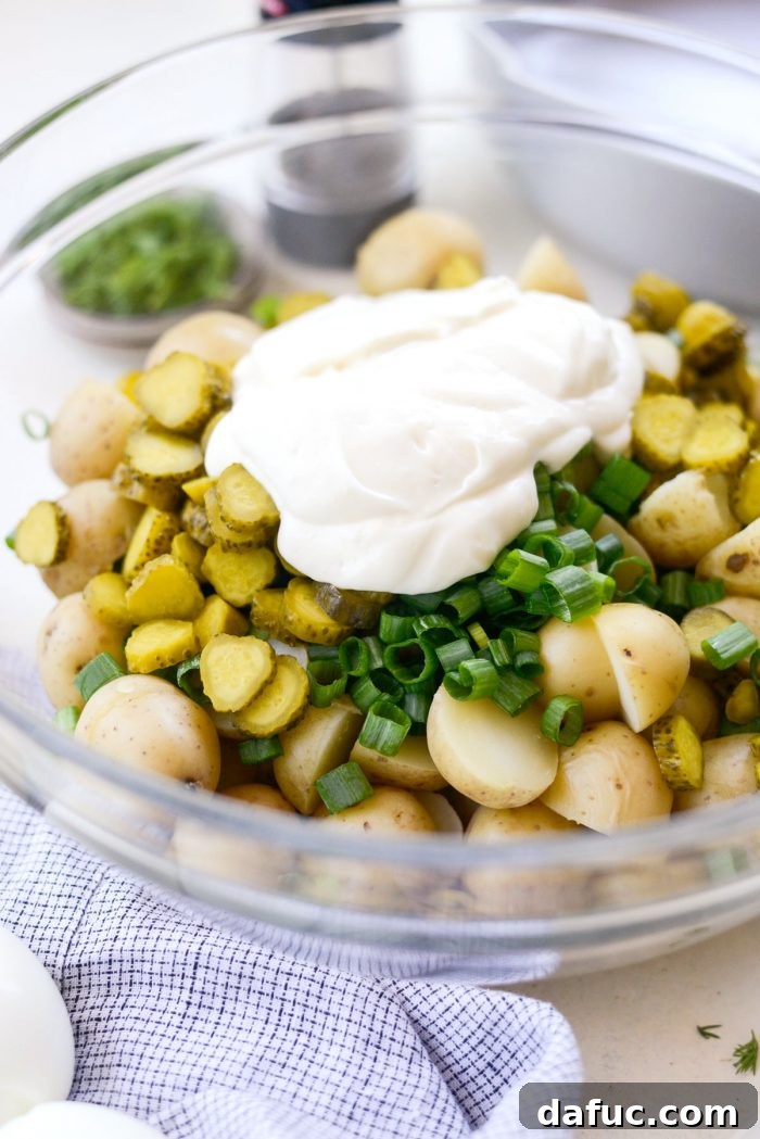 Pucker-Up Potato Salad 11 Chopped potatoes, green onions, and sliced dill pickles in a large mixing bowl, ready for the dressing.
