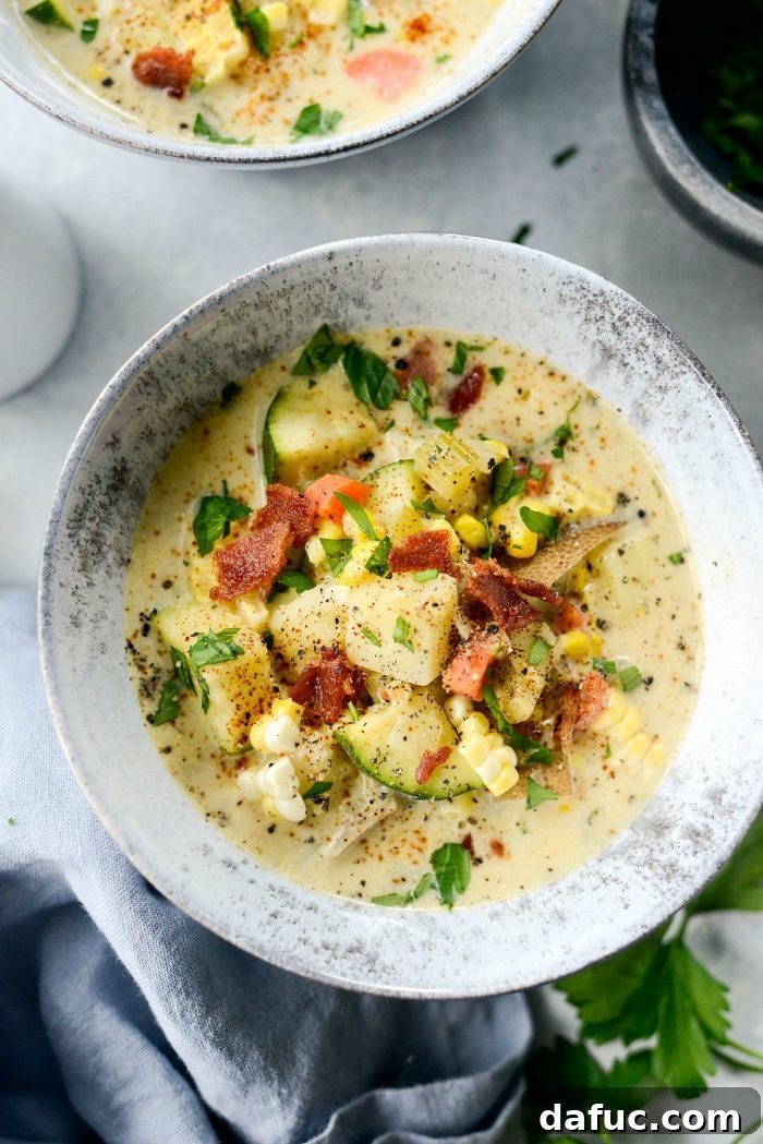 Golden Harvest Corn and Zucchini Chowder 9 A final, mouth-watering image of Summer Corn and Zucchini Chowder in a bowl, garnished with fresh herbs and black pepper, ready to be enjoyed.