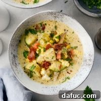 Golden Harvest Corn and Zucchini Chowder 12 A delicious bowl of Summer Corn and Zucchini Chowder with fresh garnish.
