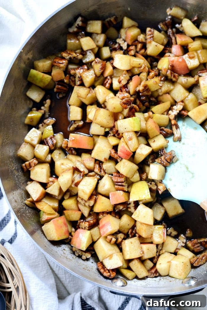 Cooking apples and pecans with spices and brown sugar.