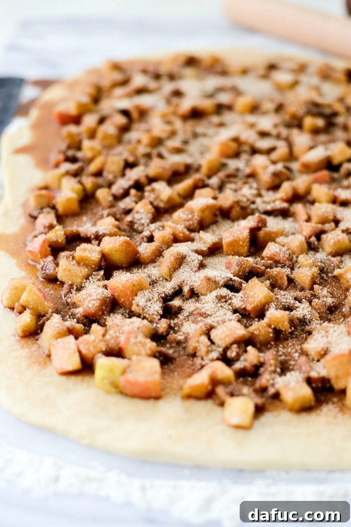 Spreading apple pecan chai filling over the dough.