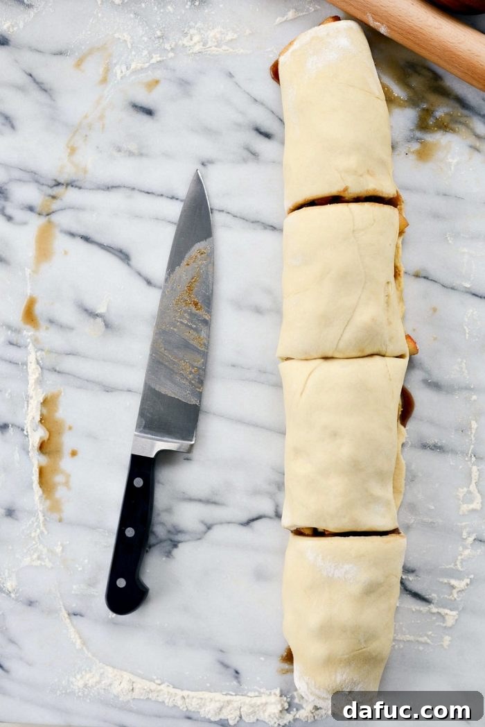 Rolling the dough with filling into a log.