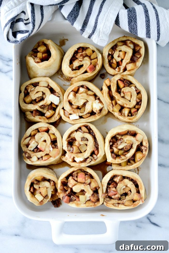 Sliced cinnamon rolls placed in a baking dish.